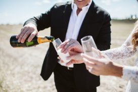 Groom during champagne in field