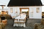 white farmhouse with long table running though building